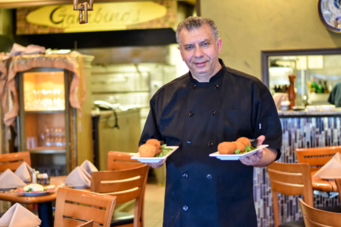 Giovanni Gambino preparing handmade arancini in his South Jersey kitchen